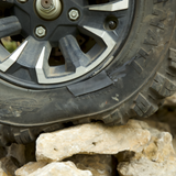 Off-road tire on a rocky terrain with a sidewall tire patch
