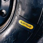 Close-up of a tire with a Blutrebaé label on a blurred background